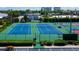 Aerial view of tennis courts, showcasing the community's recreational amenities and manicured grounds at 6600 Sunset Way # 118, St Pete Beach, FL 33706