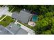 Expansive property featuring a screened pool, putting green, and outdoor seating area from above at 7320 Hideaway Trl, New Port Richey, FL 34655