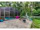 Inviting outdoor space with a screened pool area, a fire pit, and ample patio seating at 7320 Hideaway Trl, New Port Richey, FL 34655