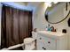 Bathroom featuring vanity sink, a toilet, and a shower with a dark shower curtain at 7320 Hideaway Trl, New Port Richey, FL 34655
