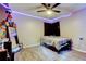 Nicely appointed bedroom with wood-look vinyl floors, a ceiling fan and LED lighting at 7320 Hideaway Trl, New Port Richey, FL 34655