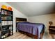 Bedroom with wood floors, storage shelves, a wooden bed frame, and a blue comforter at 7320 Hideaway Trl, New Port Richey, FL 34655