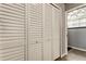 Hallway closet with plenty of storage with white bifold doors at 7320 Hideaway Trl, New Port Richey, FL 34655
