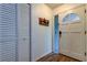 Bright entryway features a closet, hardwood floors, and decorative details at 7320 Hideaway Trl, New Port Richey, FL 34655