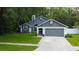 Charming home exterior features a two-car garage, manicured lawn, and inviting entrance at 7320 Hideaway Trl, New Port Richey, FL 34655