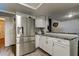 Modern kitchen featuring stainless steel refrigerator, granite countertops, and subway tile backsplash at 7320 Hideaway Trl, New Port Richey, FL 34655