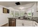 Kitchen featuring a bay window, granite countertops, and stainless steel dishwasher at 7320 Hideaway Trl, New Port Richey, FL 34655