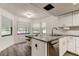 Bright kitchen featuring a bay window, granite countertops, and stainless steel appliances at 7320 Hideaway Trl, New Port Richey, FL 34655