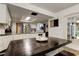 Open concept kitchen with white cabinets, a stainless steel refrigerator, and a dark wood dining table with booth seating at 7320 Hideaway Trl, New Port Richey, FL 34655