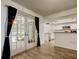 Bright living room featuring modern flooring and sliding glass doors leading to the pool area at 7320 Hideaway Trl, New Port Richey, FL 34655