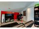 Spacious living room area with a large TV, gaming system, closet, and a futon for extra seating at 7320 Hideaway Trl, New Port Richey, FL 34655