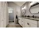 Main bathroom features dual sinks, granite countertops, modern lighting and mirrors, with tile flooring at 7320 Hideaway Trl, New Port Richey, FL 34655