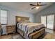 Light-filled main bedroom featuring a bed with storage drawers, an area rug, and sliding doors to the pool at 7320 Hideaway Trl, New Port Richey, FL 34655