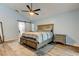 Cozy main bedroom with a sliding barn door to the bathroom and a plush bed with drawers for storage at 7320 Hideaway Trl, New Port Richey, FL 34655