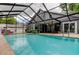 Relaxing screened pool with a covered patio and a beautifully maintained backyard at 7320 Hideaway Trl, New Port Richey, FL 34655