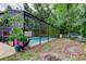 Secluded screened pool area surrounded by mature trees, offering a private oasis at 7320 Hideaway Trl, New Port Richey, FL 34655