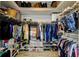 Spacious walk-in closet features plenty of storage with clothes racks, shelves, and shoe racks at 7320 Hideaway Trl, New Port Richey, FL 34655