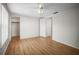 A bright bedroom with wood floors, ceiling fan, closet, and two doors at 7814 Judith Cres, Port Richey, FL 34668