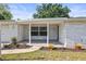 Inviting front porch with lovely landscaping, offering a welcoming entrance to the home at 7814 Judith Cres, Port Richey, FL 34668