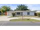 Charming single-story home featuring a well-maintained front yard and a classic brick facade at 7814 Judith Cres, Port Richey, FL 34668