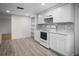 Bright kitchen showcasing white cabinets, modern appliances, and stylish backsplash at 7814 Judith Cres, Port Richey, FL 34668