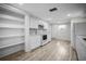 Bright kitchen featuring modern white cabinets, stainless steel appliances, and new wood flooring at 7814 Judith Cres, Port Richey, FL 34668