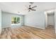 Spacious bedroom with wood-look flooring, sliding glass doors to the backyard, and ample natural light at 801 Lamont Pl, Temple Terrace, FL 33617