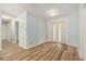 Light-filled entryway with wood-look flooring, fresh paint, and a double-door entry for a grand welcome at 801 Lamont Pl, Temple Terrace, FL 33617