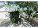 A home featuring a two-car garage, well-manicured front lawn, and white exterior at 801 Lamont Pl, Temple Terrace, FL 33617