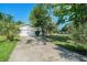 Charming single-story home with a two-car garage and a concrete driveway, partially shaded by trees at 801 Lamont Pl, Temple Terrace, FL 33617