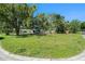 Spacious front lawn of a single-story home with a well-maintained grassy area and trees at 801 Lamont Pl, Temple Terrace, FL 33617