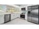 Bright kitchen features stainless steel appliances, sleek white cabinets and large picture window at 801 Lamont Pl, Temple Terrace, FL 33617