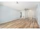 Open-concept living room featuring wood-look flooring, a ceiling fan, and plenty of natural light at 801 Lamont Pl, Temple Terrace, FL 33617