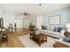 Cozy living room with modern furnishings, wood-look flooring, and plenty of space for entertaining at 801 Lamont Pl, Temple Terrace, FL 33617