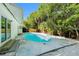 An inviting backyard pool is surrounded by white rock and a light gray concrete pool deck at 801 Lamont Pl, Temple Terrace, FL 33617