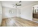 This bright bedroom features updated floors, a modern ceiling fan and ensuite bathroom at 8108 Fir Dr, Tampa, FL 33619