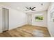 Bright bedroom featuring new floors, a ceiling fan, closet and a view to the exterior at 8108 Fir Dr, Tampa, FL 33619