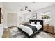 Stylishly furnished bedroom with ample light, a ceiling fan, and closet space at 8108 Fir Dr, Tampa, FL 33619