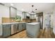 Well-lit kitchen featuring stainless steel appliances, an island, and plenty of cabinet space at 8108 Fir Dr, Tampa, FL 33619