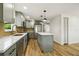 Modern kitchen with gray cabinets, stainless appliances, marble countertops and eat-in island at 8108 Fir Dr, Tampa, FL 33619