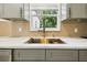 Bright kitchen showcasing a large sink, countertops, and fixtures at 8108 Fir Dr, Tampa, FL 33619