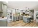 Modern kitchen featuring stainless steel appliances, an island, and hardwood flooring at 8108 Fir Dr, Tampa, FL 33619