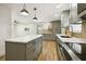Open-concept kitchen featuring new appliances, a kitchen island, and hardwood floors at 8108 Fir Dr, Tampa, FL 33619