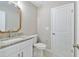Clean bathroom with a single granite vanity, neutral walls, and modern lighting at 9936 62Nd N St, Pinellas Park, FL 33782