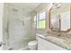 Stylish bathroom featuring a glass-enclosed shower, granite vanity, and modern fixtures at 9936 62Nd N St, Pinellas Park, FL 33782