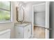 Well-lit bathroom featuring a granite countertop vanity and a decorative mirror at 9936 62Nd N St, Pinellas Park, FL 33782