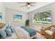 Relaxing bedroom with a large window view, light walls, and hardwood floors at 9936 62Nd N St, Pinellas Park, FL 33782