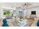 Bright living room with hardwood floors, neutral walls, and an open view of the dining area at 9936 62Nd N St, Pinellas Park, FL 33782