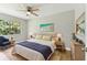 Serene main bedroom with neutral tones, hardwood floors, and ample natural light from the window at 9936 62Nd N St, Pinellas Park, FL 33782