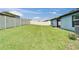 This home features a fenced-in backyard with healthy green grass at 10119 Rose Petal Pl, Riverview, FL 33578